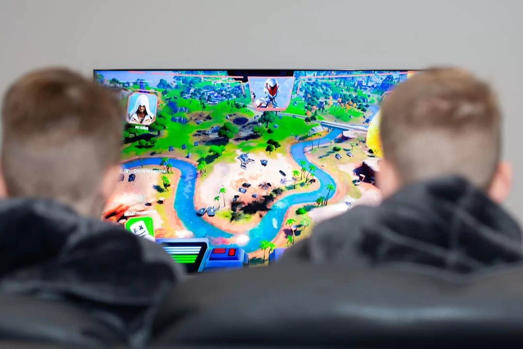 Two kids playing an old Adobe Flash Player game on a computer screen
