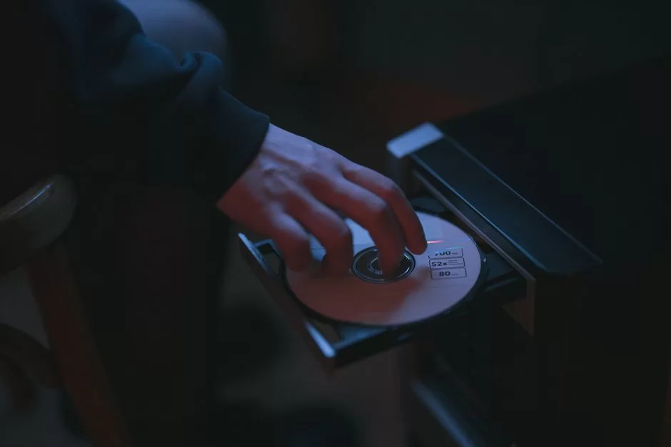 Image showing a user inserting a CD into a CD-ROM device