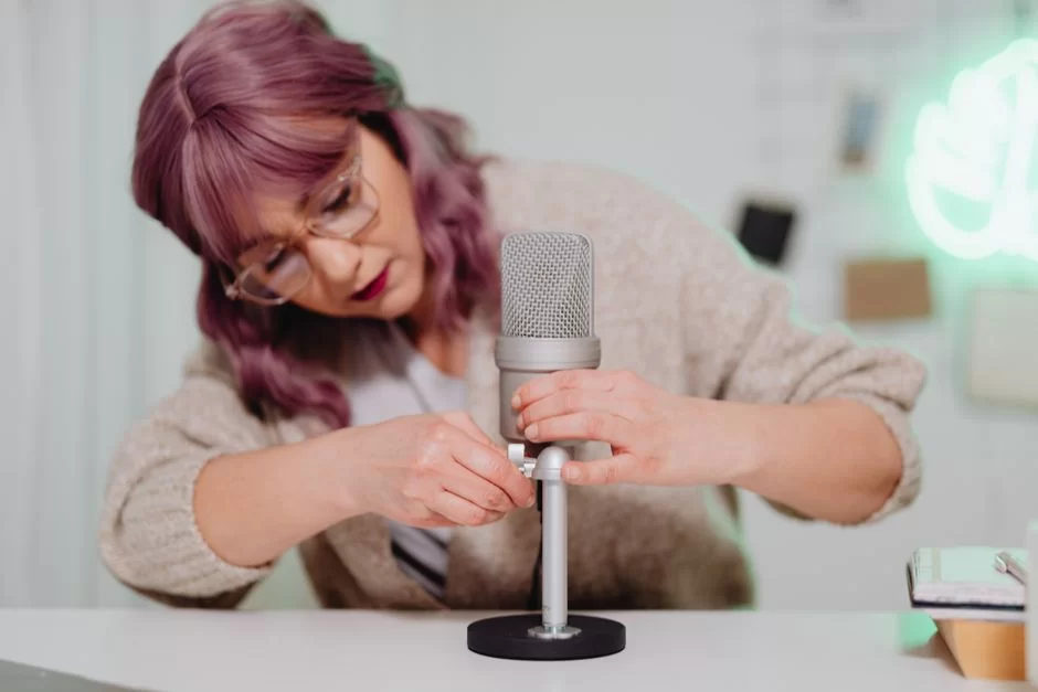 A user gently handling a microphone for cleaning and moisture protection