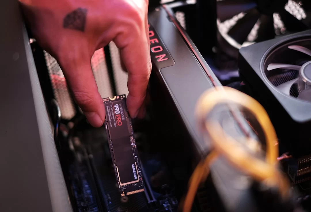 An NVMe disk being inserted or removed from a computer motherboard, showing the hot-swap feature