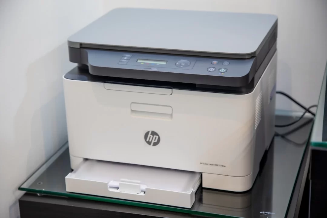 An HP brand photocopier sitting on a desk
