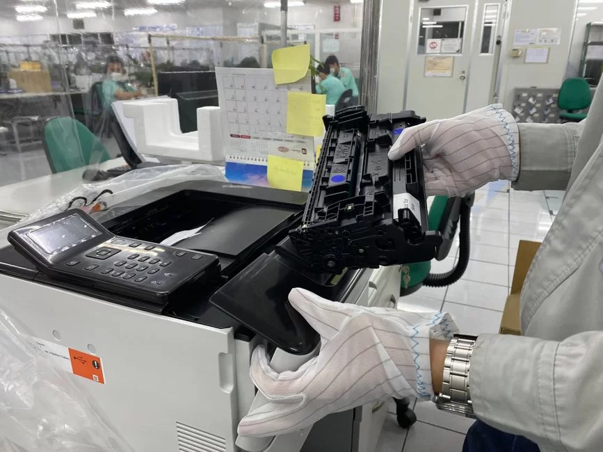 Photo showing the toner cartridge replacement process in a laser printer