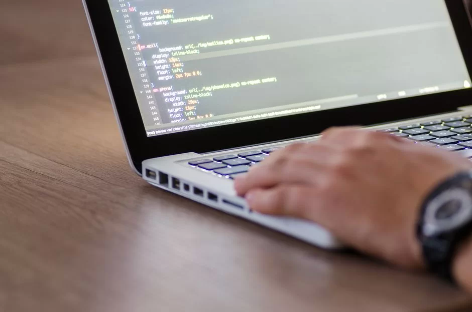 A user using a programming language on a computer screen